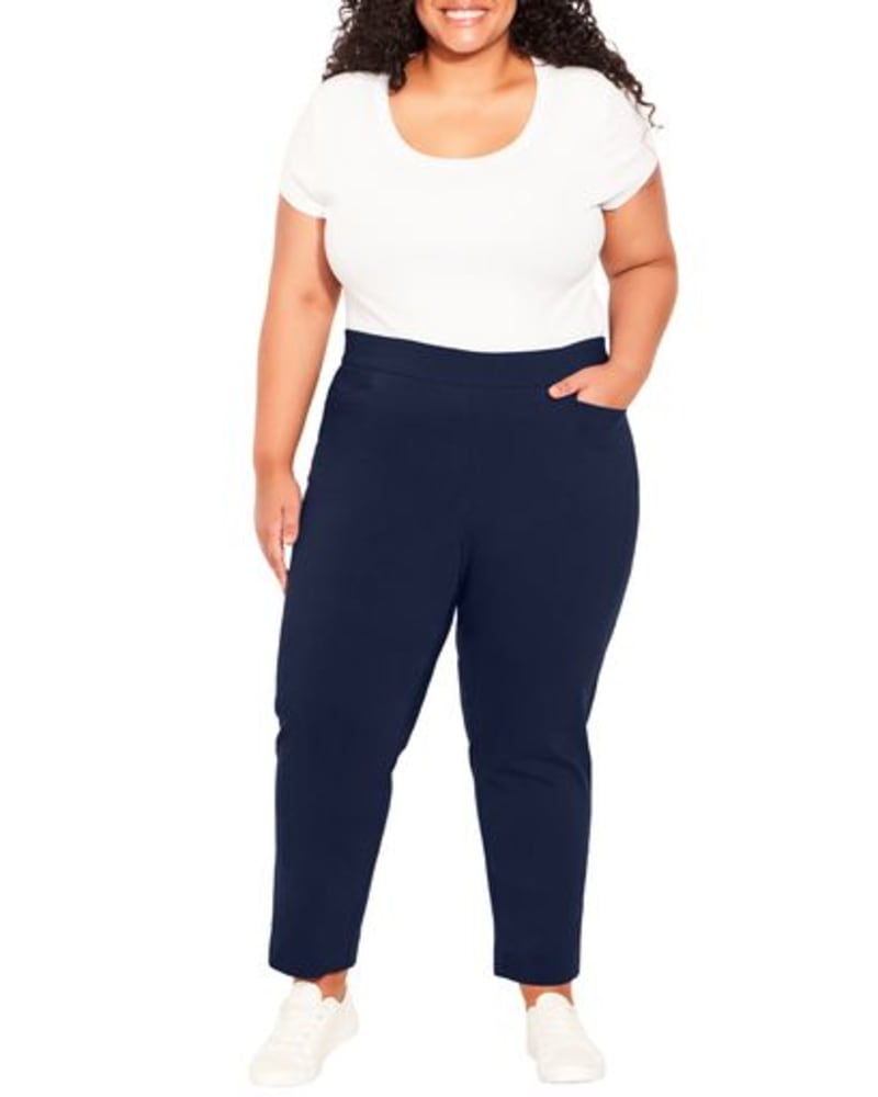 Front of a model wearing a size 14 Zuri Cropped Pull On Pant in Navy by avenue. | dia_product_style_image_id:273080